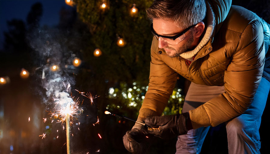 Man Wearing Protective Glasses Lighting Firework